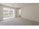 Bright bedroom boasts neutral carpet, a sliding glass door to a balcony, and ample natural light for a serene atmosphere at 11300 N Casa Dega Dr # 1044, Surprise, AZ 85388