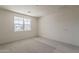 Bright, carpeted bedroom featuring a large window and neutral paint at 11300 N Casa Dega Dr # 1044, Surprise, AZ 85388