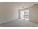Inviting bedroom boasts neutral carpet, a sliding glass door to a balcony, and ample natural light for a serene atmosphere at 11300 N Casa Dega Dr # 1044, Surprise, AZ 85388