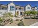 Charming townhome featuring a stylish white facade, manicured landscaping, and a welcoming walkway, ideal for modern living at 11300 N Casa Dega Dr # 1044, Surprise, AZ 85388