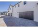 Multiple modern garages featuring dark doors and paver driveways at 11300 N Casa Dega Dr # 1044, Surprise, AZ 85388