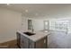 Modern kitchen island with sink, faucet, and hardwood floors at 11300 N Casa Dega Dr # 1044, Surprise, AZ 85388