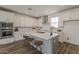 Modern kitchen with white cabinets, stainless steel appliances, and large center island at 11300 N Casa Dega Dr # 1044, Surprise, AZ 85388