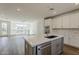 Modern kitchen with stainless steel appliances, island with sink, and hardwood floors at 11300 N Casa Dega Dr # 1044, Surprise, AZ 85388