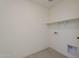 Minimalist laundry room featuring tile flooring, a shelf, and hookups for a washer and dryer at 11300 N Casa Dega Dr # 1044, Surprise, AZ 85388
