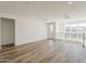 Spacious living area features hardwood floors, and large windows creating an open, inviting atmosphere filled with natural light at 11300 N Casa Dega Dr # 1044, Surprise, AZ 85388
