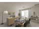 Bright home office with a modern wood desk, decor, three chairs and balcony access at 11300 N Casa Dega Dr # 1044, Surprise, AZ 85388
