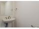 Modern powder room with white sink, mirror, and hardware at 11300 N Casa Dega Dr # 1044, Surprise, AZ 85388