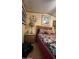 Cozy bedroom featuring a patchwork quilt and wood furnishings at 11596 W Sierra Dawn Blvd # 64, Surprise, AZ 85374