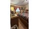 Bedroom with neutral walls, wooden headboard and a patterned bedspread at 11596 W Sierra Dawn Blvd # 64, Surprise, AZ 85374
