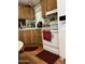 Cozy kitchen features wooden cabinets, laminate floors, and modern appliances at 11596 W Sierra Dawn Blvd # 64, Surprise, AZ 85374