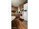 Traditional kitchen featuring wooden cabinets, white appliances, and dining space at 11596 W Sierra Dawn Blvd # 64, Surprise, AZ 85374