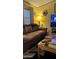 Comfortable living room with a brown couch, wooden coffee table, and entertainment area at 11596 W Sierra Dawn Blvd # 64, Surprise, AZ 85374