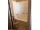 A bathroom with tiled floors, a white shower/tub, and a toilet at 12639 N 113Th Dr, Youngtown, AZ 85363