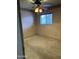 A bedroom with neutral walls, carpet, and a ceiling fan with lighting at 12639 N 113Th Dr, Youngtown, AZ 85363
