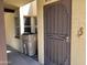 View of the entryway, highlighting the security door and adjacent window with desert-themed accents at 12639 N 113Th Dr, Youngtown, AZ 85363