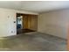 Open-concept living area showcasing neutral tones and seamless transition to adjacent dining space at 12639 N 113Th Dr, Youngtown, AZ 85363