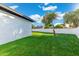 Spacious backyard with green grass, mature tree and white brick fence at 1317 E Verlea Dr, Tempe, AZ 85282
