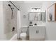 Well-lit bathroom features a tub/shower combination and a sleek vanity with a black faucet and mirror at 1317 E Verlea Dr, Tempe, AZ 85282