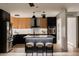 Modern kitchen with two-toned cabinetry, stainless appliances, island seating, and modern pendant lighting at 1317 E Verlea Dr, Tempe, AZ 85282