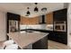 Modern kitchen highlighting two-tone cabinets, a central island, modern pendant lighting, and stainless appliances at 1317 E Verlea Dr, Tempe, AZ 85282
