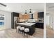 Stylized kitchen showcasing stainless steel appliances, wood and black cabinets, plus central island with seating at 1317 E Verlea Dr, Tempe, AZ 85282