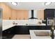 Modern kitchen boasts stainless appliances, two-tone cabinets, quartz countertops, and stylish fixtures at 1317 E Verlea Dr, Tempe, AZ 85282