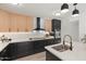 The modern kitchen features stainless appliances, stylish fixtures, two-tone cabinets, and quartz countertops at 1317 E Verlea Dr, Tempe, AZ 85282