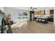 Open-concept living area with fireplace, pool access, kitchen island, and bar stool seating at 1317 E Verlea Dr, Tempe, AZ 85282