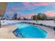 Sparkling backyard pool with patio, white brick perimeter fence, and colorful sunset sky at 1317 E Verlea Dr, Tempe, AZ 85282