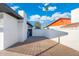 View of the side yard with brick pavers and white brick walls at 1317 E Verlea Dr, Tempe, AZ 85282