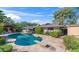 Lush backyard oasis featuring an in-ground pool, diving board, flagstone patio, shaded pergola, mature trees and home exterior at 14821 N Hana Maui Dr, Phoenix, AZ 85022