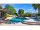 Refreshing pool and patio with lounge chairs, surrounded by lush greenery, trees and plants, plus a covered patio with seating at 14821 N Hana Maui Dr, Phoenix, AZ 85022
