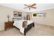 Comfortable bedroom featuring neutral tones, a ceiling fan, and a well-lit window, enhancing a relaxing ambiance at 14821 N Hana Maui Dr, Phoenix, AZ 85022
