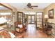 Cozy living room with Saltillo tile floors, leather chairs, and French doors leading to the backyard at 14821 N Hana Maui Dr, Phoenix, AZ 85022