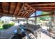 Covered patio featuring comfortable seating, a ceiling fan, and views of the pool and backyard at 14821 N Hana Maui Dr, Phoenix, AZ 85022