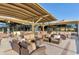 Outdoor patio lounge area featuring wicker furniture under a covered structure with golf course views at 14821 N Hana Maui Dr, Phoenix, AZ 85022