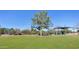 Sunny playground featuring colorful play structures and green grass under a clear blue sky at 14821 N Hana Maui Dr, Phoenix, AZ 85022