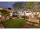 Expansive backyard featuring a patio, dining area, manicured lawn, and fire pit, perfect for relaxation and entertaining at 1513 W Mitchell Dr, Phoenix, AZ 85015