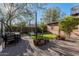 Large backyard with a dining set and fire pit, framed by well-maintained landscaping at 1513 W Mitchell Dr, Phoenix, AZ 85015