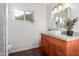 Bright bathroom featuring modern vanity with mosaic countertop and wooden cabinets at 1513 W Mitchell Dr, Phoenix, AZ 85015