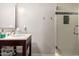 Bathroom with a stylish vanity, elegant mirror, and a glass-enclosed tiled shower at 1513 W Mitchell Dr, Phoenix, AZ 85015