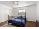Cozy bedroom with a wrought iron bed frame, natural light, and ample closet space at 1513 W Mitchell Dr, Phoenix, AZ 85015