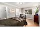 Bright bedroom featuring a wrought iron bed frame, wood floors, and a map accent wall at 1513 W Mitchell Dr, Phoenix, AZ 85015