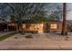 Charming brick home featuring desert landscaping, stepping stones, and a covered parking area at 1513 W Mitchell Dr, Phoenix, AZ 85015