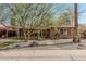 Daytime front view of a charming brick home featuring desert landscaping and a covered parking area at 1513 W Mitchell Dr, Phoenix, AZ 85015