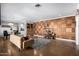 Spacious living room featuring wood paneling, a comfortable sofa, and stylish decor at 1513 W Mitchell Dr, Phoenix, AZ 85015