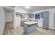 Inviting kitchen with gray cabinets, white countertops, and a functional center island at 15443 N 86Th Ln, Peoria, AZ 85382