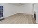 Bright living room featuring wood floors and a fireplace, with a door to the outside at 15443 N 86Th Ln, Peoria, AZ 85382
