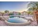 The backyard has a luxurious pool with stone features and a well-maintained landscape at 15443 N 86Th Ln, Peoria, AZ 85382